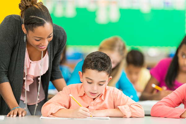 teacher helping students in class