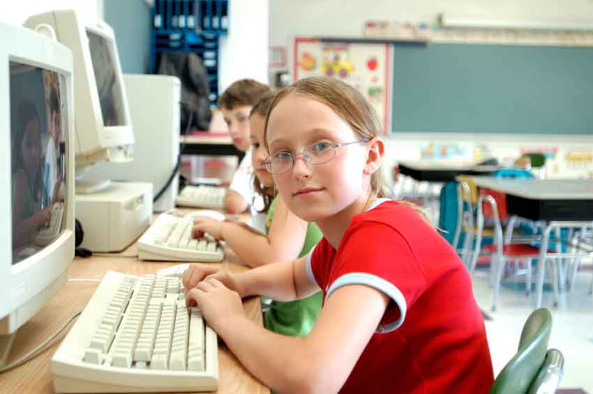 photo of students in a classroom on computers